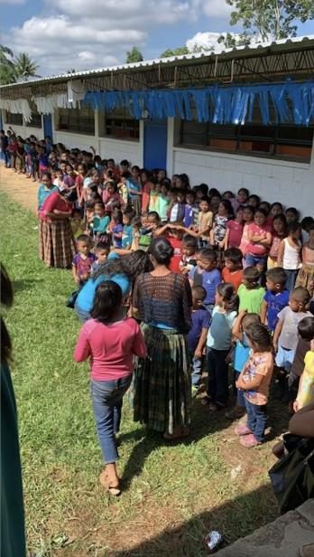 Families lining up at a GEF backpack giveaway