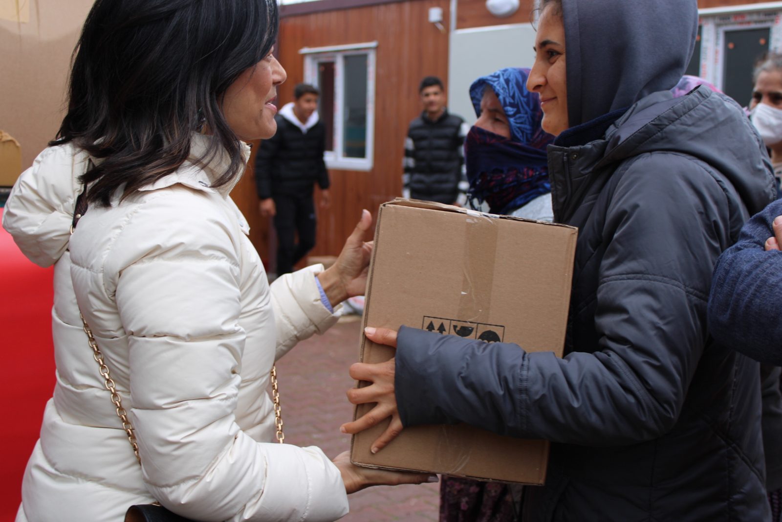 Charlene Nijmeh hands a relief box to a woman