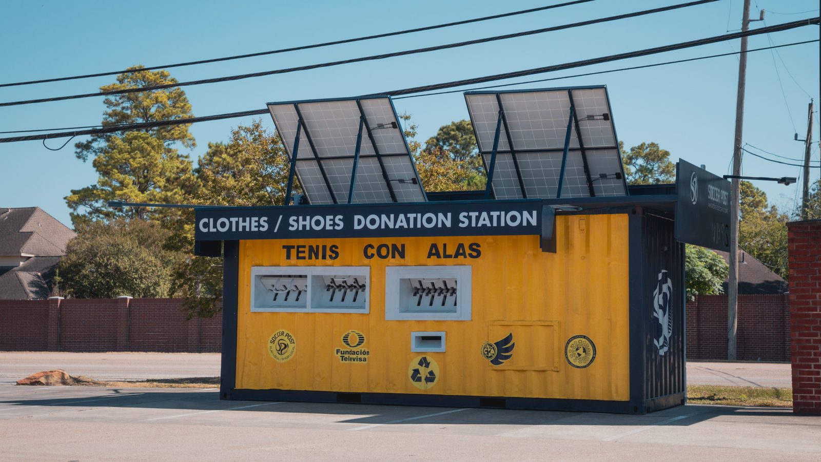 Yellow, solar-powered Tenis con Alas clothes and shoes donation station in Houston