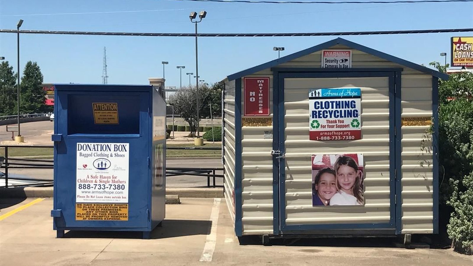Two unattended donation drop-off boxes in a parking lot