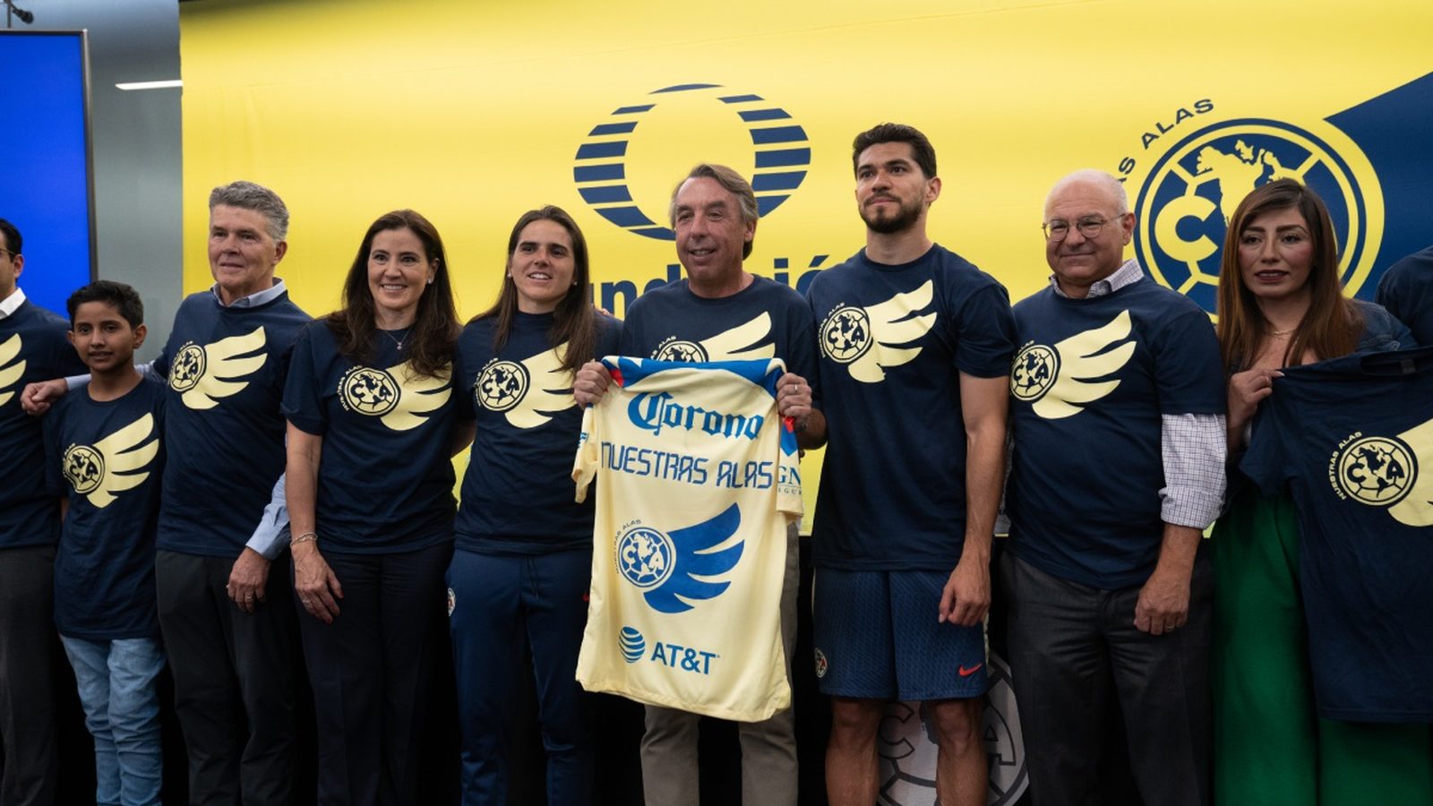 Club América players and partners holding a Nuestras Alas jersey at the program launch